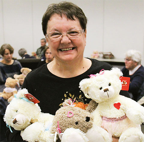 Retiree Ann Cherney holds some of the dozens of Joy Bears made by RC 10 members to help comfort cancer patients. Photo by Andrew Watson.