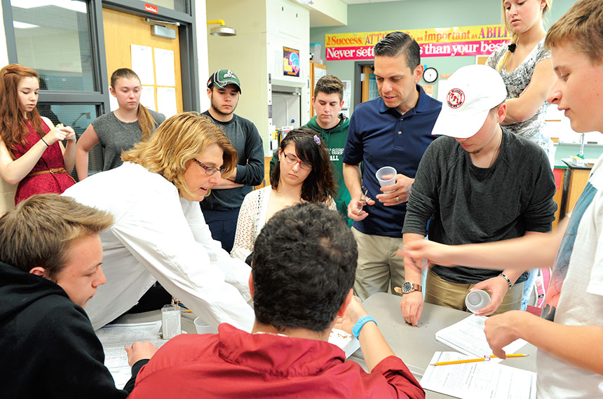 Assemblyman Angelo Santabarbara (standing, center) and Schalmont High School students get ready to work together on a biology project with Schalmont TA science teacher Michele Freeman. Photo by El-Wise Noisette.