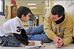 teacher helps student with project
