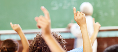 k12 educators - students with hands raised