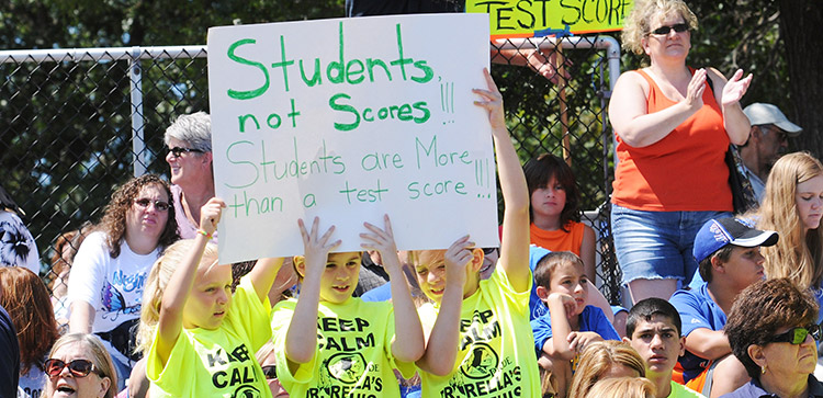 students not scores sign at rally