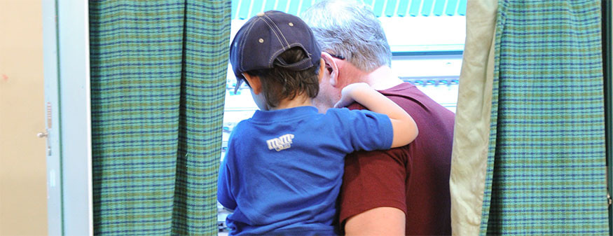 voter at the poll with grandson