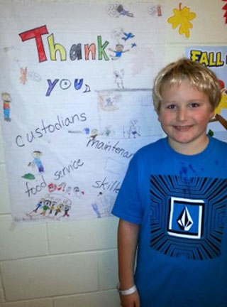 SRP Recognition - Miller Mietus, third-grader at Scribner Road Elementary School, with a poster he and classmates completed to thank SRPs in Mrs. Sherrill Moon’s class.