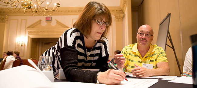 Getting down to business: Maryann Caposella of New Rochelle F.U.S.E. and Alan Dust of the Whitesboro Employees Union. Photo by Marty Kerins.