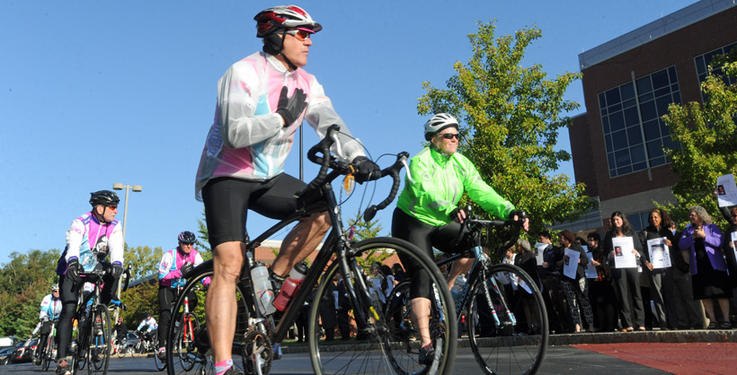 Riders cycle past NYSUT headquarters in Latham early in the morning of their 100-mile bike ride to pay tribute to Colin Gillis, an 18-year-old who went missing two years ago, and the relative of a NYSUT staff person. Photo by El-Wise Noisette.