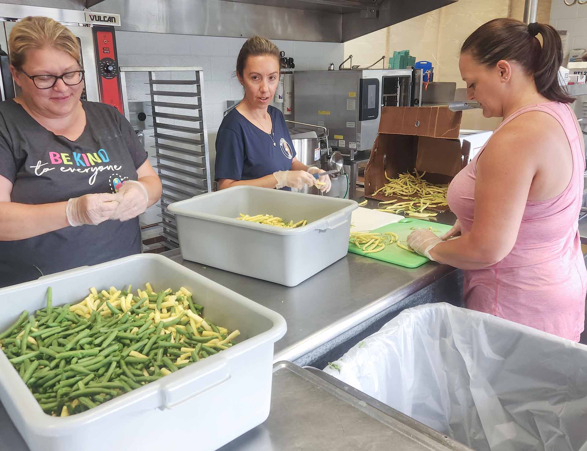 This summer, Attica Central School District team members (left to right) Melissa Brooks, Amanda Brown, and Jenelle Bauer helped the district break down and preserve produce from local farms for school meals.