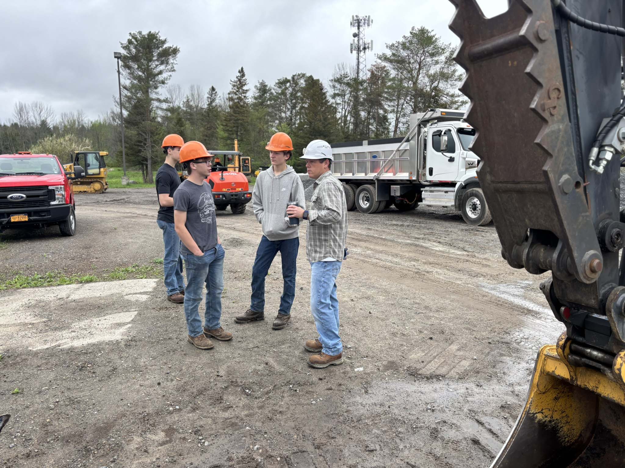 Students in Hamilton-Fulton-Montgomery BOCES’s Environmental Conservation class learn from instructor Craig Newkirk how to detach a shovel from an excavator. Students are responsible for the care and maintenance of all heavy equipment used in the class.