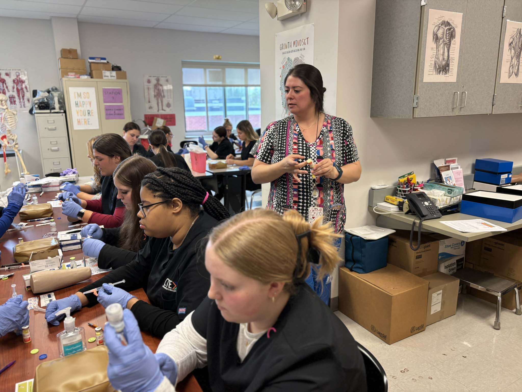  Lauren Wohlgemuth, medical assisting instructor at Hamilton-Fulton-Montgomery BOCES helps students reconstitute powder medications.