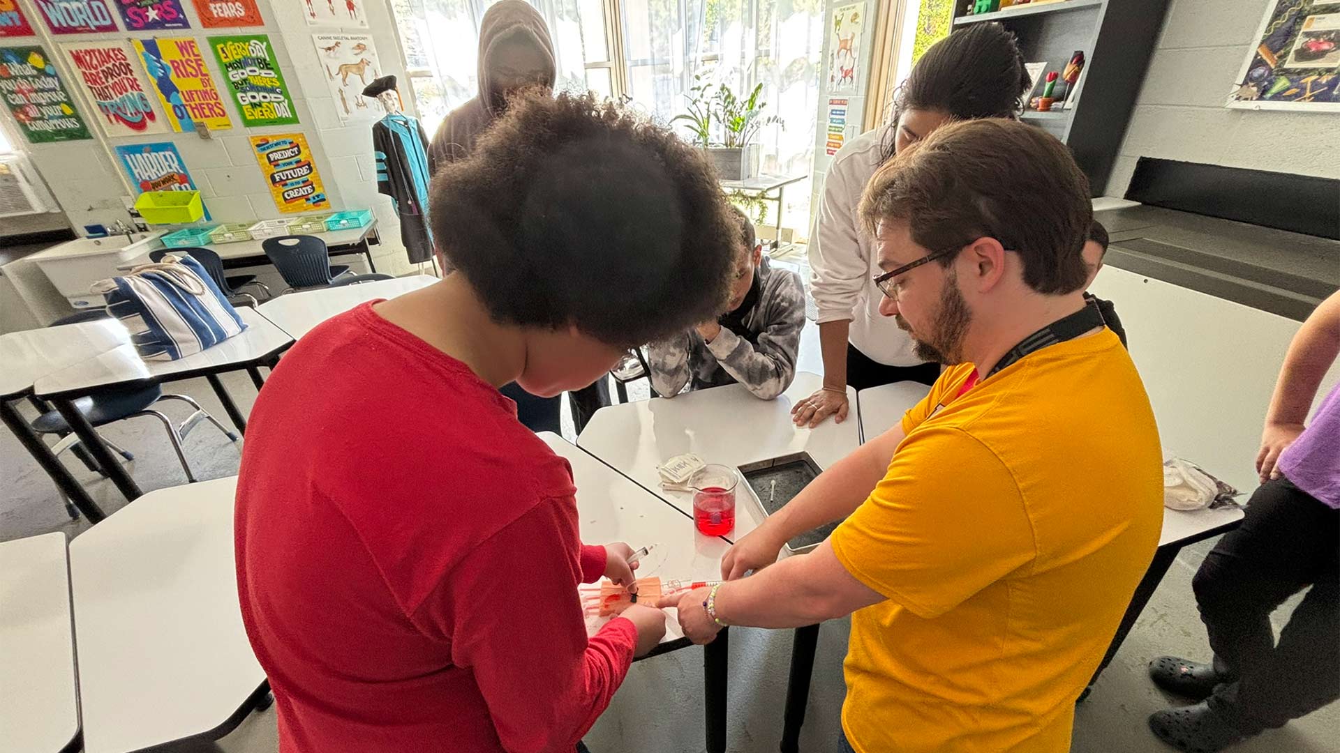 Dr. Maksim Vasilevsky, member of the Greenburgh North Castle United Teachers shows Demarko Fields Amarante and the rest of the students in his Veterinary Medicine Assistant program at the Kenneth B. Clark Academy how to draw blood. 