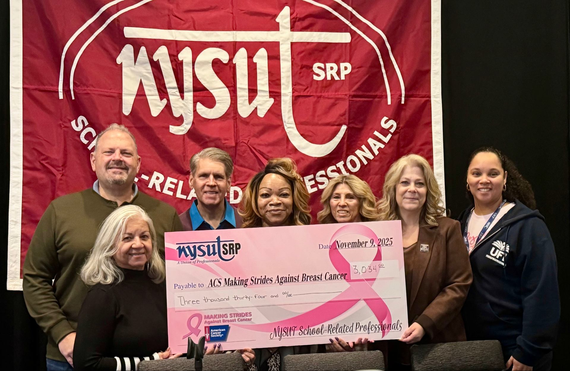 Generosity at the 2025 SRP Leadership Conference: (Clockwise from left) SRP At-Large Director Angie Rivera; 2nd Vice President Ron Gross; Private Sector Higher Ed At-Large Director Stephen Rechner; SRP Advisory Committee Chairperson Karen McLean; and SRP At-Large Directors Karen Lee Arthmann, Kim McEvoy and Priscilla Castro with check to the American Cancer Society’s Making Strides Against Breast Cancer. (Photo by Leslie Fottrell)