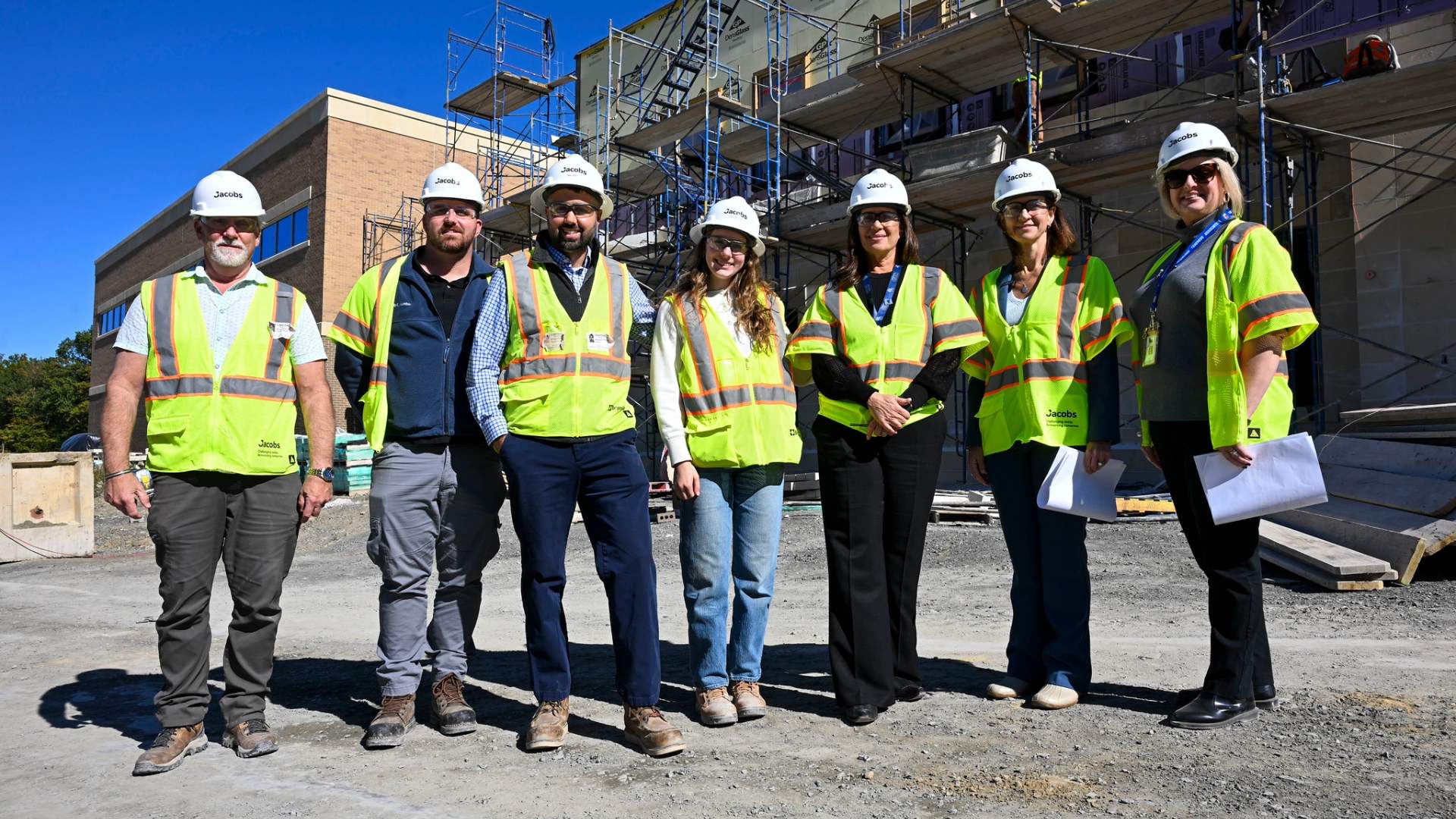 NYSUT President Melinda Person (second from right) with Newburgh Teachers Association President Stacy Moran (right) stand in front of the Newburgh Free Academy Career and Technical Education Center, slated to open in September 2026. 