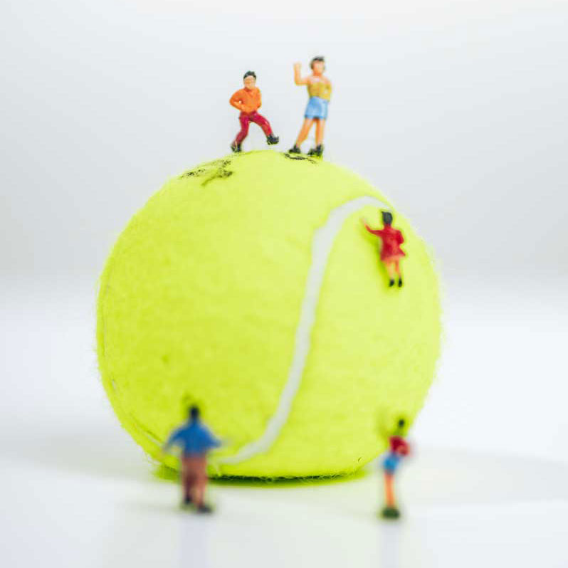 Figurines of children playing on a tennis ball