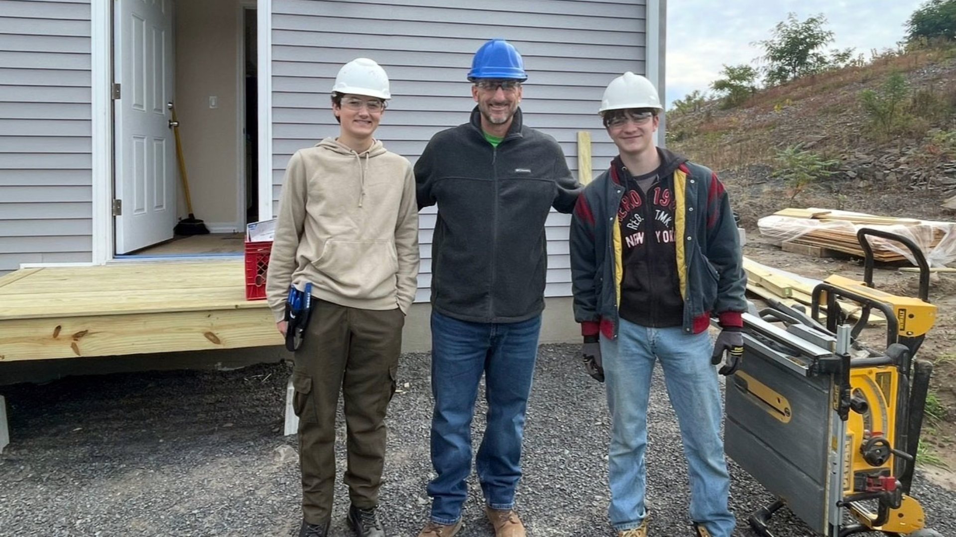 Saugerties counselor Michael Catalano with Ulster BOCES students at a Habitat for Humanity building site. 