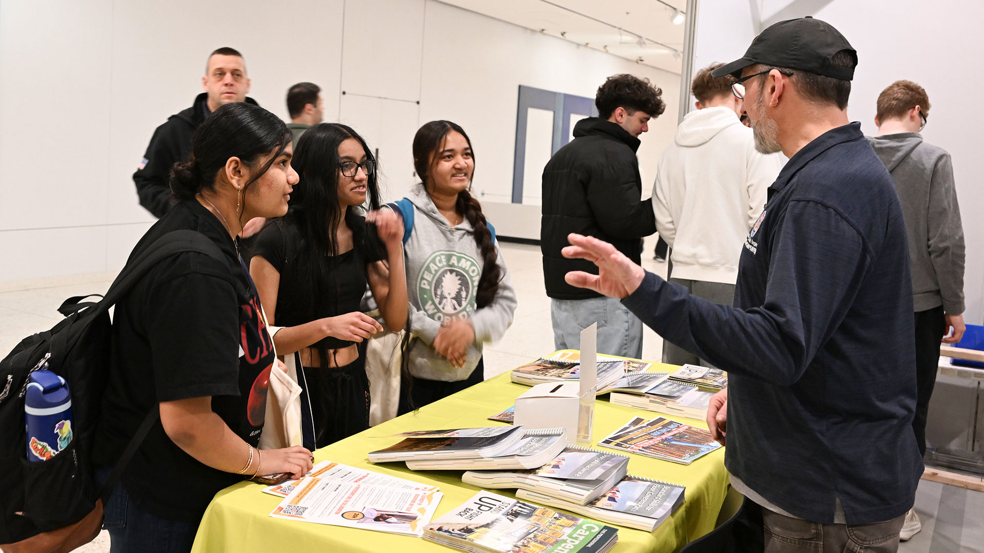 Students visit Carpenters Local 291 booth to learn more about the building trades at the annual Apprenticeship Works showcase at Empire State Plaza. 