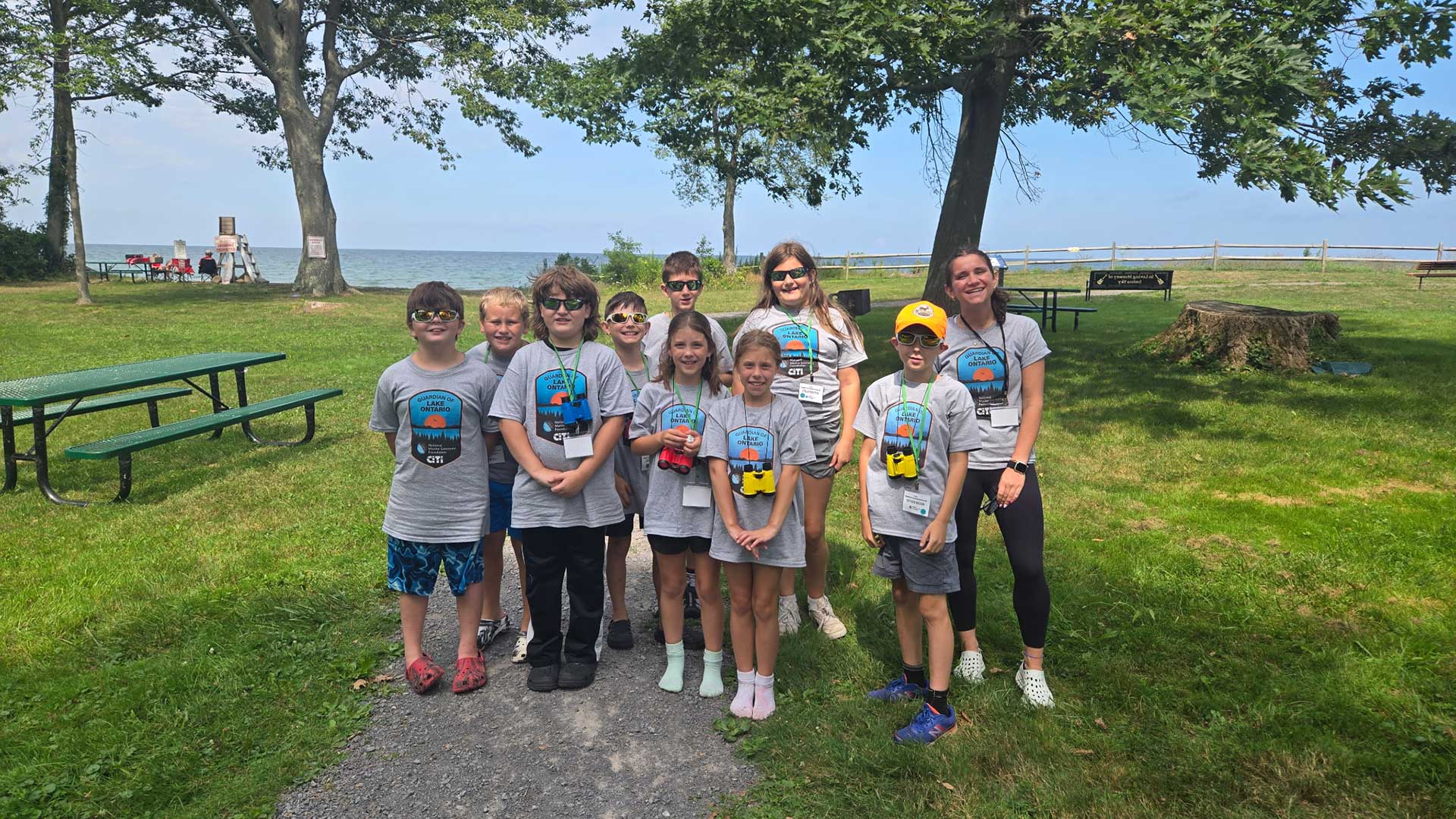  Fifth-grade teacher, Caroline Wilkinson (far right) and her students visited Lake Ontario as part of the Guardians of Lake Ontario Sanctuary Camp, a weeklong summer camp designed to raise awareness about this national marine sanctuary. 