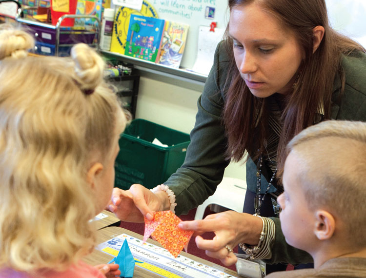 Duanesburg second-grade teacher Erin Goodwin, a member of the Duanesburg Teachers Association, demonstrates how to make an origami peace crane.