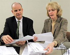 NYSUT officers Lee Cutler and Kathleen Donahue review applications for assistance through NYSUT's Disaster Relief Fund.