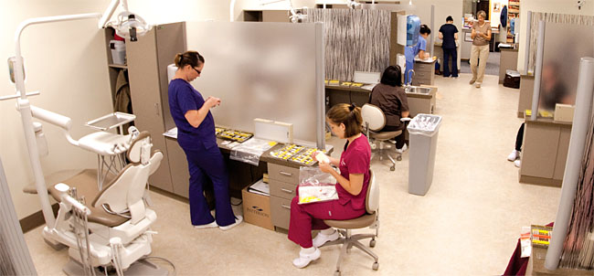 Monroe Community College dental students assist in the campus-based clinic and help operate a school-based health clinic in School 17 in Rochester. Photo by Jeremy Case. 