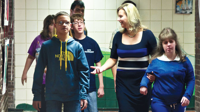 Ashli Skura Dreher walks with her students between class at Lewiston-Porter High School. 