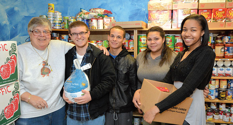 From left, Mary Ann Borrello, a Faculty Association of Suffolk Community College member, helps stock the union’s food pantry along with student volunteers Christopher Somma, Islam Eltahlawy, Diamond Bates and Emaje Green. The FASCC donates to food pantries on all three SCC campuses to help students in need. Photo by Kevin Peterman.
