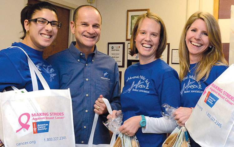 Poughkeepsie educators Jennifer Ortiz, Amy Cramer and Mary Ellen Trocino, pictured with NYSUT Secretary-Treasurer Lee Cutler, hold goodies for families. Photo by Maria R. Bastone.