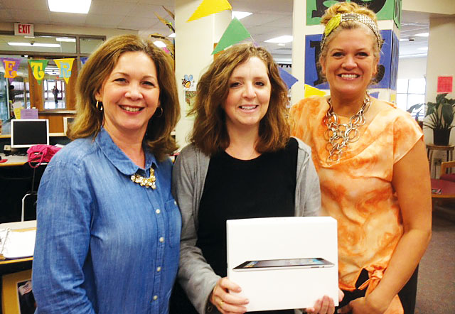From left, Baldwinsville TA Vice President Julia Yando and President Beth Chetney congratulate member Kim Charest, center, on winning the local’s most recent disaster relief raffle. The BTA raised nearly $1,500 by raffling off a new iPad, with all proceeds going to the NYSUT Disaster Relief Fund. The BTA, a 2010 graduate of the NYSUT Local Action Project, conducts annual fundraisers to support the NYSUT fund.
