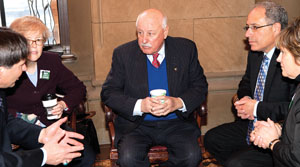 From left, UUP's Fred Kowal, PSC's Barbara Bowen, NYSUT Executive VP Andy Pallotta and community college leader Ellen Schuler Mauk talk with Senate Higher Education Chair Ken LaValle, center. Photo by Marty Kerins Jr.