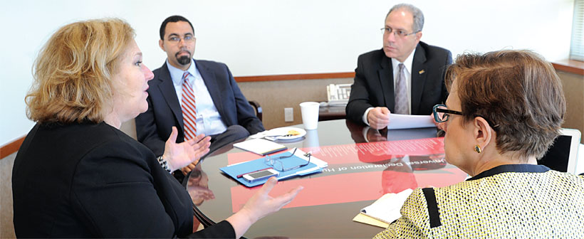 NYSUT President Karen E. Magee, left, accompanied by, at right, Executive Vice President Andy Pallotta and Vice President Catalino Fortino, delivers NYSUT’s vote of ‘no confidence’ to State Education Commissioner John King Jr., top left, at a meeting at NYSUT headquarters during Magee’s first days as union president.