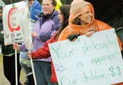 Undaunted by the cold and rain, parents, children and educators picket to defend public education in Lake Placid.