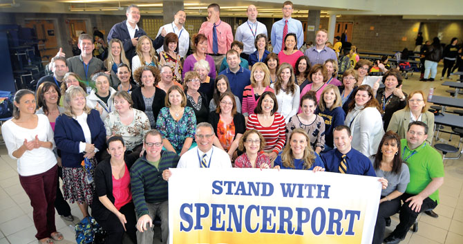 NYSUT members in Spencerport spearheaded an online petition drive against SED’s testing policies. Holding the banner in Cosgrove Middle School are, from left, Spencerport TA President John Kozlowski, Claudia Montecalvo, Emmy Thevanesan and Rob Allen.