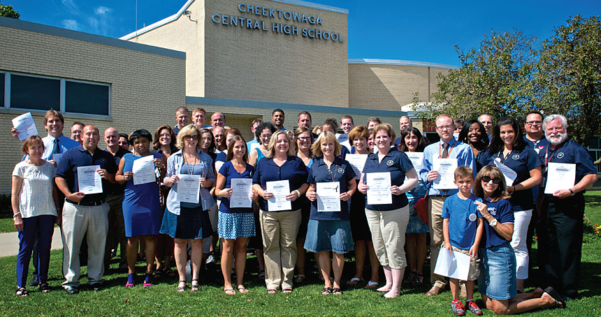 Cheektowaga Central School educators, members of the Cheektowaga Central TA, join in a Day of Action held across western New York to open the school and "Respect Public Schools." The Cheektowaga CTA members hold copies of a pledge they took to "respect each of my students as a unique person, not a test score." Photo by Dennis Stierer.