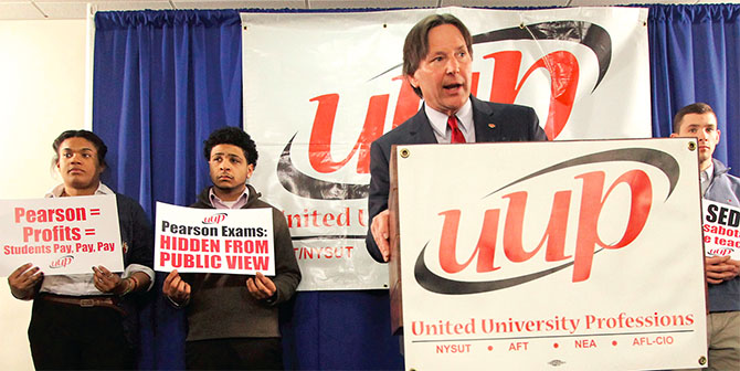 UUP President Fred Kowal, flanked by SUNY students, calls for an investigation into SED's newly implemented, and problematic, teacher certification exams. Photo by Mike Lisi.