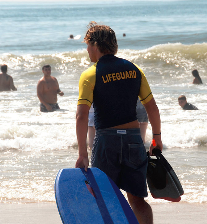 A member of the Jones Beach chapter of the New York State Lifeguards Corps/UUP patrols the beach. Miller Photography. 