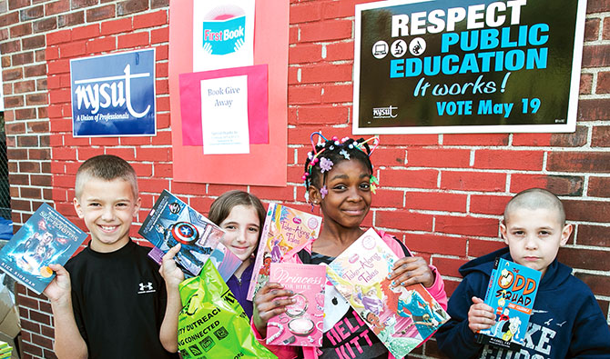 Schenectady elementary students Ryan, Abby, Ayariyana and Jeremy show off their new books. Photo by Marty Kerins Jr. 