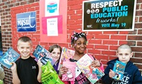 Schenectady elementary students Ryan, Abby, Ayariyana and Jeremy show off their new books. Photo by Marty Kerins Jr. 