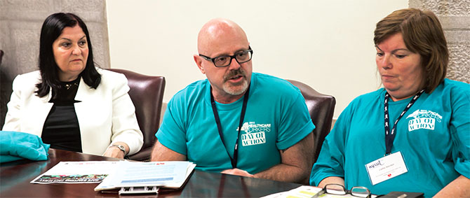 Anne Goldman, a UFT vice president and chair of NYSUT's Health Care Professionals Council, and nurses Howard Sandau and Cathy Sinclair, UFT Federation of Nurses members, press their case to lawmakers. Photo by Marty Kerins Jr. 