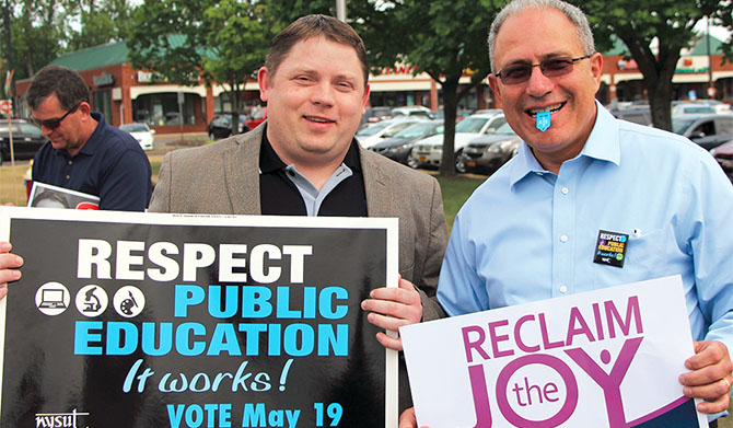 NYSUT officers Martin Messner, left, and Andy Pallotta help get out the vote for school budgets. Photo by Nicholas Dicocco. 