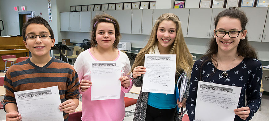 From left: Minisink students Michael, Adrianna, Jenna and Hannah hold the letters they wrote to soldiers.