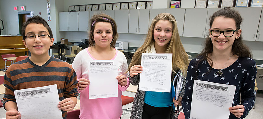 From left: Minisink students Michael, Adrianna, Jenna and Hannah hold the letters they wrote to soldiers.