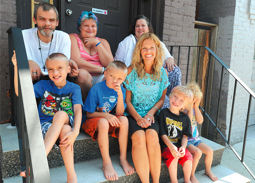 Troy teacher Noelle Frederick, front center, and teaching assistant Marilyn Barton, back right, make a home visit with Joseph and Stephanie Williams and their four children. Educators at Troy School 2 met with more than 100 families before school began.