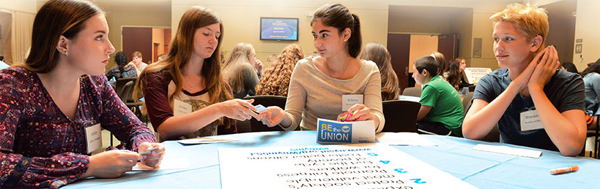 From left, students Ashley Davidson, Jordan Scull, Rebecca Hyatt and Braeden Arthur use NYSUT’s Why in 5 cards to start a conversation about various social justice topics. Photo by El-Wise Noisette.