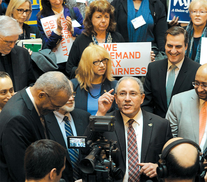 NYSUT’s Andy Pallotta, above, tells hundreds of coalition activists about his “bucket list” at a rally on the Capitol’s Million Dollar Staircase.