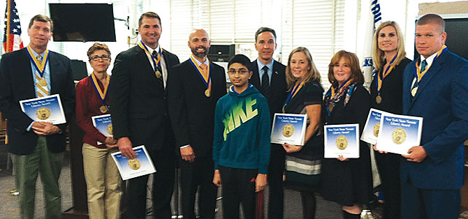 Sen. Jack Martins, R-Mineola, presents Herricks educators with the Liberty Medal of Honor for saving eighth-grader Shanketh Kumar, center.