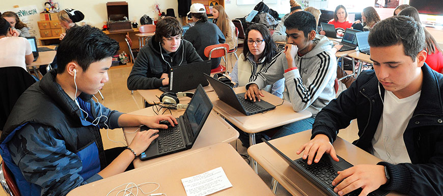Guilderland Central Teachers Association member Kim Ruppel, center, an English as a New Language teacher, works with students, from left, Jie Weng, Tufan Oner, Vineeth Inuganty and Sergio Medina.