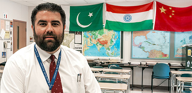 Todd Hathaway, East Aurora Faculty Association member who teaches a foreign policy class, uses the recent immigrant policy shifts to teach students how to unpack and question the rationale behind the policies and discover whether the changes are warranted. Photo by Dennis Stierer.