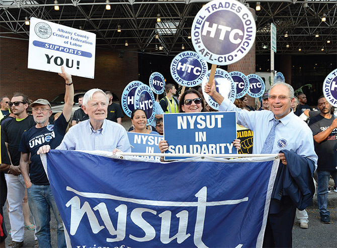 NYSUT Board member Anthony McCann, RC 10, joins NYSUT President Andy Pallotta and other activists in boycotting and picketing outside the Albany Hilton, whose new owners refuse to agree to a fair contract.