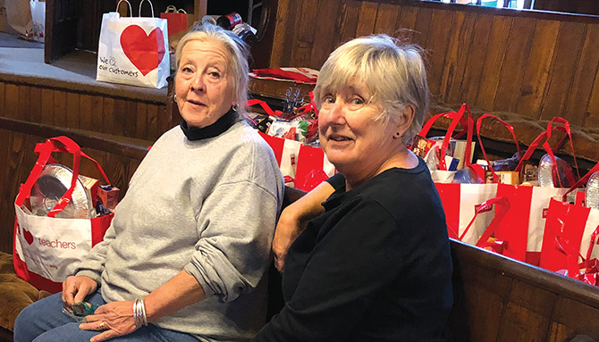 Maryelisa Blundell, RC 15, works with in-service members of the Red Hook Faculty Association to distribute free bags and books at a community event. 