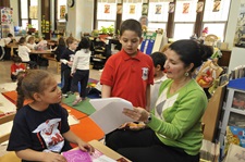Teacher speaking with two students