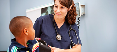 health care professionals - nurse checks student's blood pressure