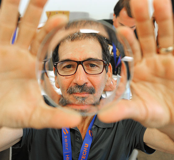 Steven Birnbaum, a member of the Wappingers Congress of Teachers, looks through a petri dish during the Semi High Tech U workshop for teachers. For more on this story, visit www.nysut.org.